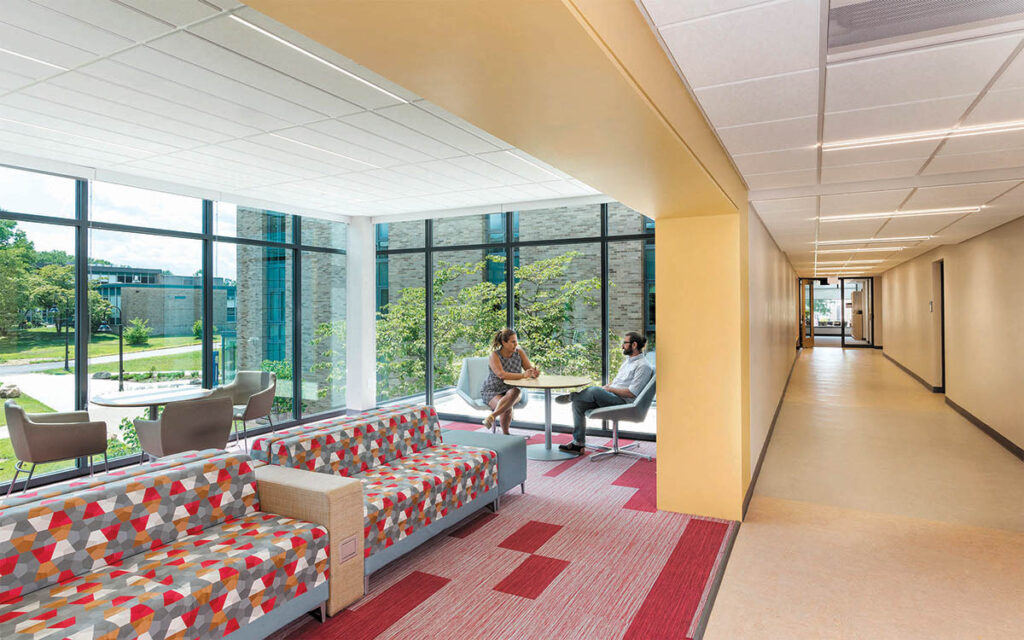 MEETING SPACE: Light-filled lounges on each floor connect office and classroom wings, providing space for casual meetings and group study.