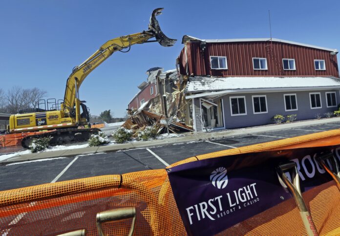 AN EXCAVATOR demolishes a building during an official groundbreaking in Taunton,, where the Mashpee Wampanoag tribe was to build the First Light Resort & Casino. The project was halted shortly afterward when a group of residents sued, arguing the federal government couldn't take the land into trust for the tribe. / AP FILE PHOTO/ELISE AMENDOLA AN EXCAVATOR demolishes a building during an official groundbreaking in Taunton,, where the Mashpee Wampanoag tribe was to build the First Light Resort & Casino. The project was halted shortly afterward when a group of residents sued, arguing the federal government couldn't take the land into trust for the tribe. / AP FILE PHOTO/ELISE AMENDOLA