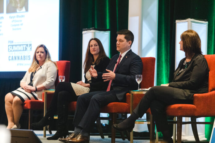 BENJAMIN L. RACKLIFFE, second from right, an attorney at Pannone Lopes Devereaux & O’Gara LLC, speaks during a panel discussion at Providence Business News' Business of Cannabis Summit on Wednesday in Providence. Also on the panel was, from left, Karyn Rhodes, of Complete HR Solutions; Mitzi Hollenbeck, of Citrin Cooperman; and Kristyn Glennon of BayCoast Bank. / PBN PHOTO/RUPERT WHITELEY