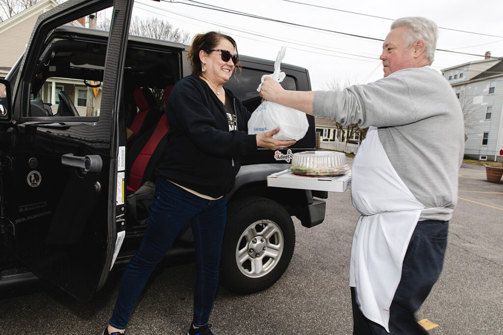 SPECIAL DELIVERY: Perella’s Ristorante chef-owner Lou Perella not only cooks the food but is now delivering it, here to CJ Audet-Kelly. / PBN FILE PHOTO/RUPERT WHITELEY