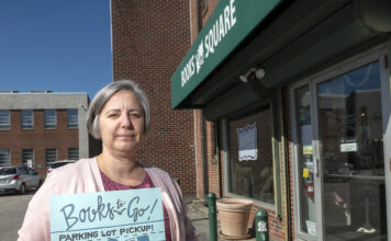 BOOKS TO GO: Jennifer Kandarian, manager of Books on the Square in Providence, has opened a drive-up book drop at the back door for elderly patrons and others too nervous to walk inside the store during the COVID-19 pandemic. / PBN PHOTO/MICHAEL SALERNO