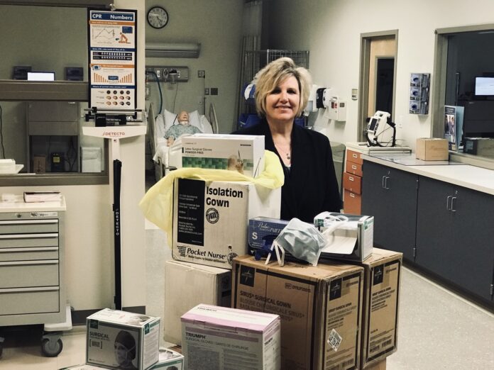 NEW ENGLAND INSTITUTE of Technology Director of Nursing and Interim Assistant Provost of Health Services Darlene Noret stands with medical supplies the school will donate Tuesday to Care New England to help with the COVID-19 pandemic. / COURTESY NEW ENGLAND INSTITUTE OF TECHNOLOGY NEW ENGLAND INSTITUTE of Technology Director of Nursing and Interim Assistant Provost of Health Services Darlene Noret stands with medical supplies the school will donate Tuesday to Care New England to help with the COVID-19 pandemic. / COURTESY NEW ENGLAND INSTITUTE OF TECHNOLOGY