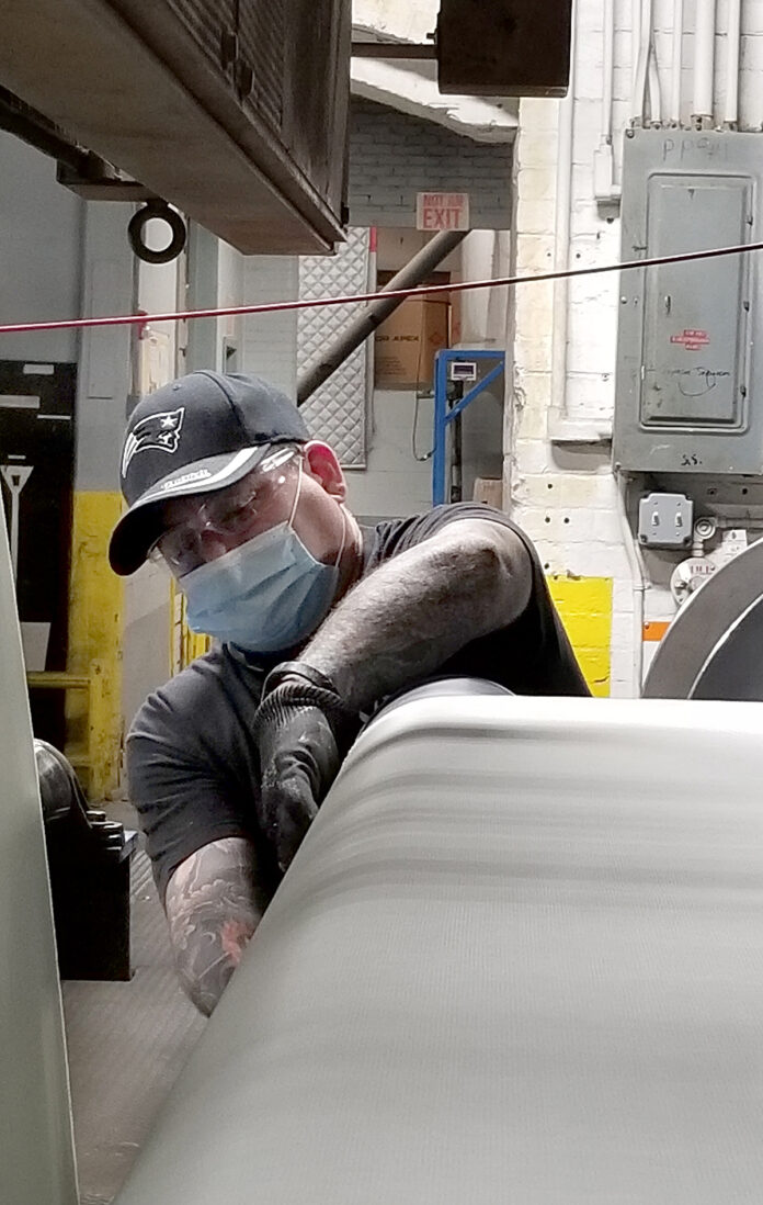 ON TASK: Art Levesque works on the coating line on third shift at Cooley Group in Pawtucket. / COURTESY COOLEY GROUP