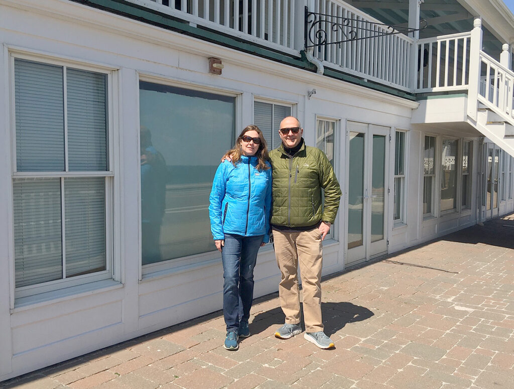 LOCKED UP: John and Sarah Cullen stand outside Block Island Tees, one of three shops they own at the National Hotel. Their stores remain shuttered during the pandemic. / PBN PHOTO/KARI CURTIS 