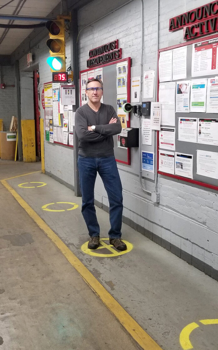 SOCIAL DISTANCING: Daniel Dwight, CEO and president of Pawtucket-based Cooley Group, shows how employees practice social distance inside the Cooley plant. / COURTESY COOLEY GROUP
