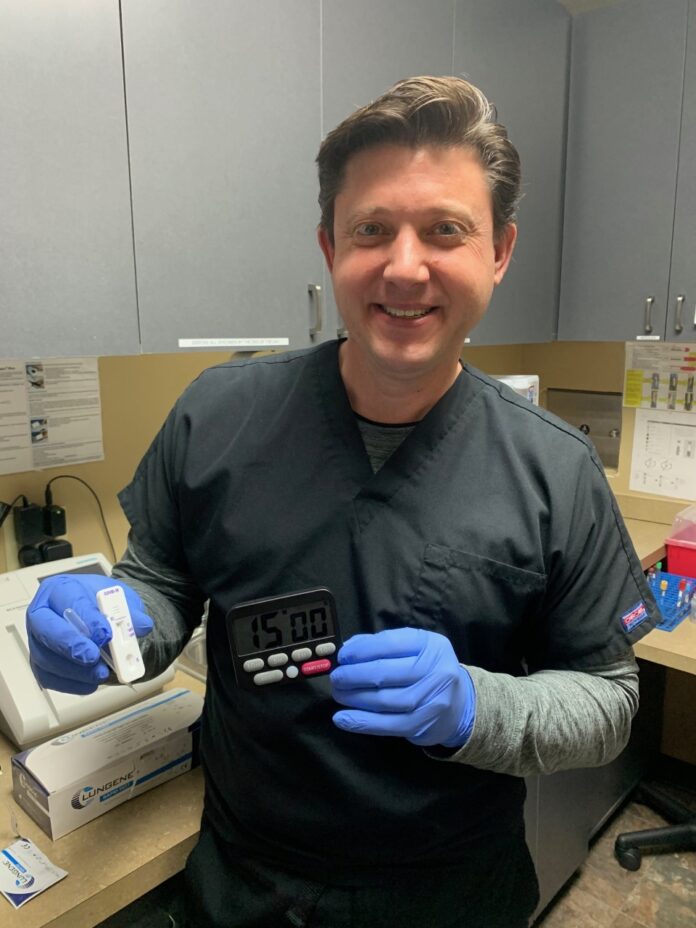 DR. RYAN WELTER, CEO of Tristan Medical North Attleboro Care Center, holds a new blood tests that can held determine signs of COVID-19 in 15 minutes. The facility is offering drive-thru testing for individuals. / COURTESY TRISTAN MEDICAL NORTH ATTLEBORO CARE CENTER DR. RYAN WELTER, CEO of Tristan Medical North Attleboro Care Center, holds a new blood tests that can held determine signs of COVID-19 in 15 minutes. The facility is offering drive-thru testing for individuals. / COURTESY TRISTAN MEDICAL NORTH ATTLEBORO CARE CENTER