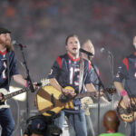 Drive-in concerts reviving live music IN THE FLESH: The Eli Young Band perform during halftime of an NFL football game in Houston in 2014. The band will take the stage as part of the Concert in Your Car series in June. / AP FILE PHOTO/PATRIC SCHNEIDER