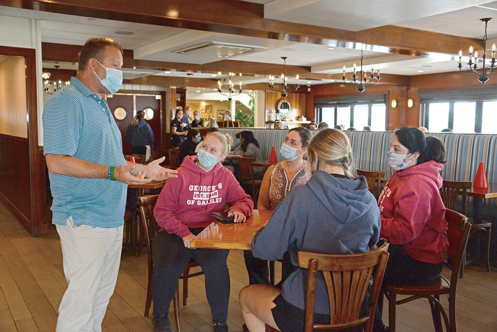 PEP TALK: Kevin Durfee, owner of George’s of Galilee restaurant in Narragansett, talks to his staff during a lunch shift. Durfee says businesses know how to keep people safe and should be allowed to reopen as long as they can ensure social-distancing measures. / PBN PHOTO/ELIZABETH GRAHAM