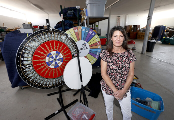 MISSING THE FUN: Dawn Abbott, CEO of Fun Productions, a small corporate-events company that she started in 1991, is shown amid the unused items in the company’s northeast Denver warehouse.  / AP PHOTO/DAVID ZALUBOWSKI