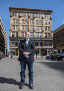 MICRO-OFFICES: Joseph R. Paolino is the managing partner of Paolino Properties LP, which owns the building on Weybosset Street in Providence in the background. Paolino plans to create a series of micro-offices on the first floor instead of retail to provide more individualized spaces to help reduce the spread of COVID-19. / PBN PHOTO/MICHAEL SALERNO