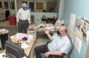 CUTTING COSTS: Beacon Communications Inc. owner John Howell, left, speaks with Cranston Herald Managing Editor Daniel Kittredge. Howell laid himself off recently before securing a federal Paycheck Protection Program loan of $190,000, which will temporarily help his payroll. / PBN PHOTO/MICHAEL SALERNO