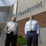 DIVERSE WORKFORCE: C.C. Business Corp. Vice President Ron Brewer, left, and President Marcellus Sharpe stand outside of Thundermist Health Center in Woonsocket, one of the private-security company’s clients. Brewer estimates that 70% of the company’s 39 employees are minorities. / PBN PHOTO/RUPERT WHITELEY