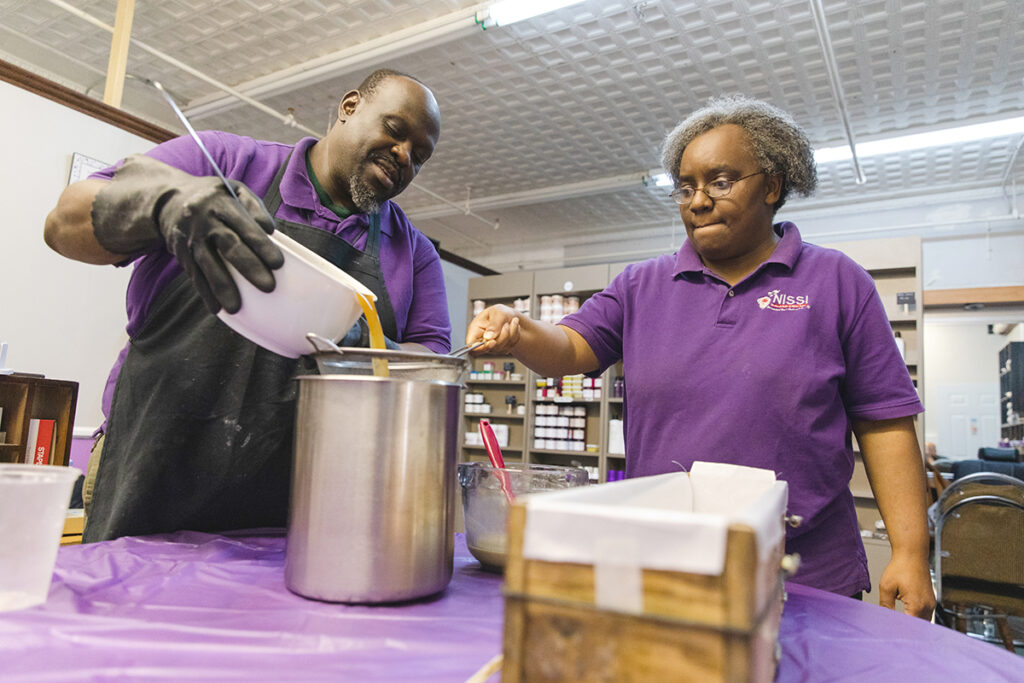 UPHILL BATTLE: Nissi Naturals co-owners Andrew and Anna Mangeni make soap. Anna Mangeni says starting and growing the hair and skin care products store has been challenging because it’s difficult to access capital as a minority-owned business. PBN PHOTO/MICHAEL SALERNO