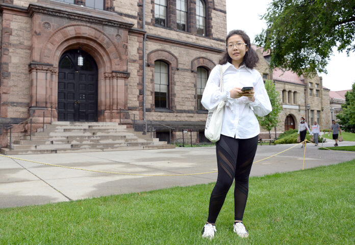 DISTANCE LEARNING: As a precaution against COVID-19, international student Grace Deng, who will be a senior this year at Brown University, plans to take her courses online while living in Providence when classes resume in the fall. / PBN PHOTO/ELIZABETH GRAHAM DISTANCE LEARNING: As a precaution against COVID-19, international student Grace Deng, who will be a senior this year at Brown University, plans to take her courses online while living in Providence when classes resume in the fall. / PBN PHOTO/ELIZABETH GRAHAM