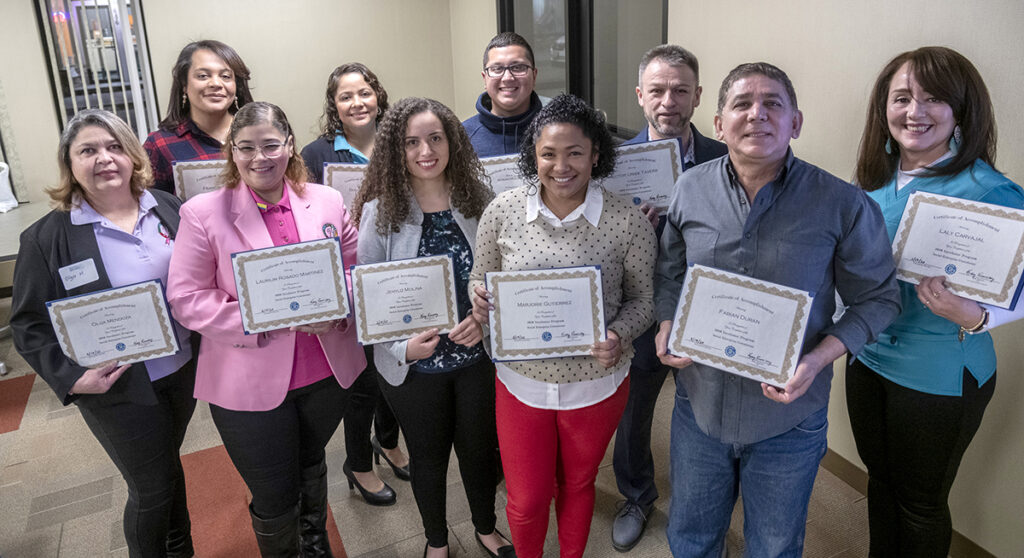 PREPARED: Graduates hold their certificates after completing Social Enterprise Greenhouse’s new incubator program designed for Spanish-speaking entrepreneurs in the Central Falls area. From 2017 to 2019, SEG has more than doubled the number of minority entrepreneurs served through its programs to 120. / PBN PHOTO/MICHAEL SALERNO