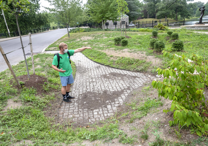 NATURAL CLEANSER: Ryan Kopp, coordinator of the Providence Stormwater Innovation Center, explains how a stormwater basin clears pollutants from runoff inside Roger Williams Park. / PBN PHOTO/MICHAEL SALERNO