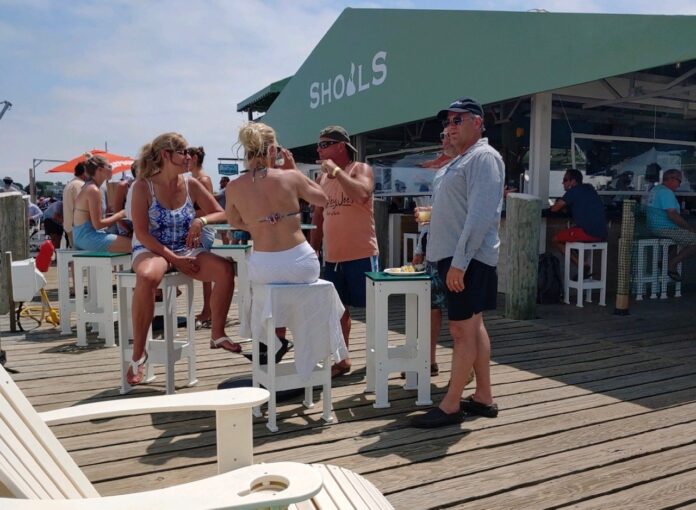 PATRONS GATHER at Mohogany Shoals on Payne's Dock in New Harbor in July. / COURTESY HENRY DUPONT