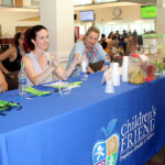 SPREADING THE WORD: Children’s Friend staffers, from left, Kristen Caine, Jennifer Paradis and Rebecca Paquette offer health information during the organization’s Wellness Fair during Children’s Friend annual staff summer outing at Rhode Island College last year. / COURTESY CHILDREN’S FRIEND