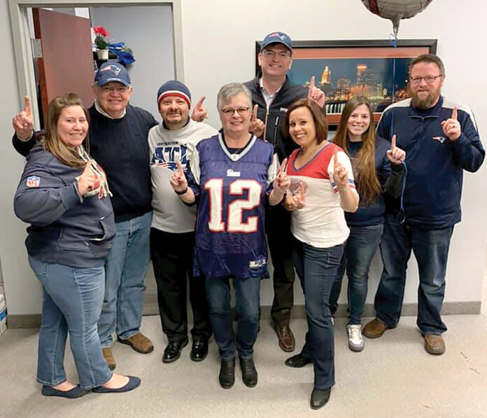 FOOTBALL FEVER: Secure Future Tech Solutions employees wear New England Patriots attire as part of a recent Patriots Spirit Day at the office.
COURTESY SECURE FUTURE TECH SOLUTIONS FOOTBALL FEVER: Secure Future Tech Solutions employees wear New England Patriots attire as part of a recent Patriots Spirit Day at the office.
COURTESY SECURE FUTURE TECH SOLUTIONS