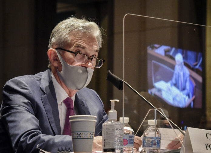 THE FEDERAL RESERVE expects to keep its benchmark interest rate pegged near zero at least through 2023. Above, Fed chair Jerome Powell. / AP FILE PHOTO/BILL O'LEARY/THE WASHINGTON POST