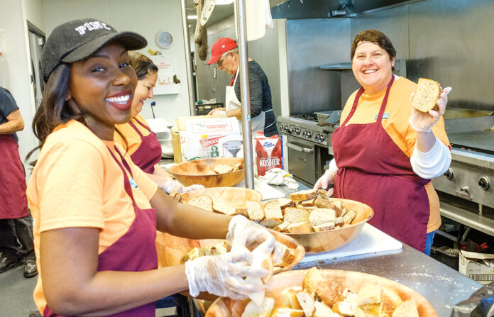 GIVING BACK: Amica Mutual Insurance Co. employees volunteer at the Amos House in Providence. / COURTESY AMICA MUTUAL INSURANCE CO.