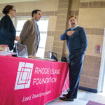 LEADING THE WAY: Rhode Island Foundation CEO and President Neil D. Steinberg, right, works with staffers at an expo event. COURTESY RHODE ISLAND FOUNDATION