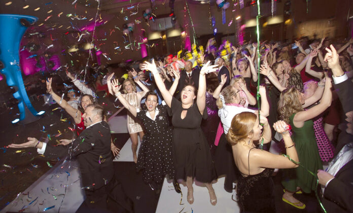LIFE’S A PARTY:  Amgen Inc. employees dance together at a  recent annual gala. / COURTESY AMGEN INC.