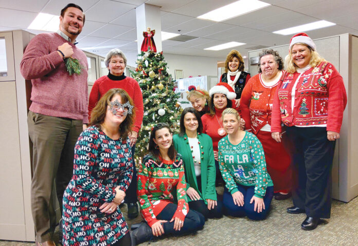 CHRISTMAS TIME: Employees at Carey, Richmond & Viking Insurance wear holiday outfits to get into the Christmas spirit.  COURTESY CAREY, RICHMOND & VIKING INSURANCE