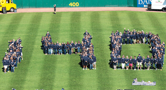 BY THE NUMBERS: Employees of Starkweather & Shepley Insurance Brokerage Inc. form a giant “140” during an annual employee appreciation day at McCoy Stadium in Pawtucket to celebrate the firm’s 140th anniversary. / COURTESY STARKWEATHER & SHEPLEY INSURANCE BROKERAGE INC. 