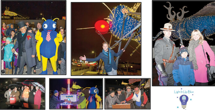 LIGHT IT UP: Employees from Big Blue Bug Solutions help light up the signature Big Blue Bug for Christmas.  COURTESY BIG BLUE BUG SOLUTIONS