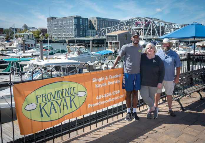 IN DEMAND: From left, Randall Ferdinand, Providence Kayak Co. employee; Kristin Stone, owner; and Tom McGinn, captain. The company, which was started three years ago, exploded in popularity this past summer, as people wanted to get outside. / PBN PHOTO/MICHAEL SALERNO IN DEMAND: From left, Randall Ferdinand, Providence Kayak Co. employee; Kristin Stone, owner; and Tom McGinn, captain. The company, which was started three years ago, exploded in popularity this past summer, as people wanted to get outside. / PBN PHOTO/MICHAEL SALERNO