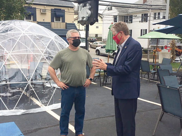 WEATHER OR NOT: Lt. Gov. Daniel J. McKee gets a closer look at an “igloo” set up at Kay’s Restaurant in Woonsocket. With McKee is Kay’s owner David Lahousse. Ten of the structures, which cost over $1,400 each, are now in place at the restaurant to extend outdoor dining. / COURTESY OFFICE OF LIEUTENANT GOVERNOR