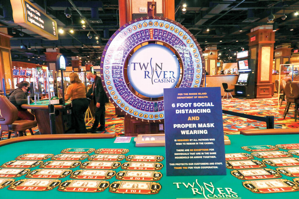 TAKING NO CHANCES: A sign on a table game at Twin River Casino Hotel warns patrons they must follow public health guidelines. The casino closed for three months early in the pandemic and has yet to return to full capacity. / PBN PHOTO/PAMELA BHATIA