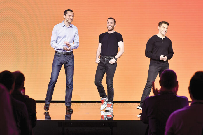 THE ORIGINALS: Airbnb co-founder and Chief Product Officer Joe Gebbia, center, with co-founder and Chief Technology Officer Nathan Blecharczyk, left, and co-founder and CEO Brian Chesky at an Airbnb event in 2016. / COURTESY AIRBNB THE ORIGINALS: Airbnb co-founder and Chief Product Officer Joe Gebbia, center, with co-founder and Chief Technology Officer Nathan Blecharczyk, left, and co-founder and CEO Brian Chesky at an Airbnb event in 2016. / COURTESY AIRBNB