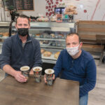 HASN’T BEEN EASY: Terry Coburn, left, and Brian Buonaiuto, co-owners of Coffee and Crumbs in Cranston, opened their shop just weeks before the COVID-19 pandemic arrived in March.  PBN PHOTO/MICHAEL SALERNO