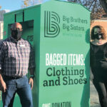 THEY’VE BIN BUSY: Katje Afonseca, right, executive director of Big Brothers Big Sisters of Rhode Island, and Lamel Moore, executive director of the East Side/Mt. Hope YMCA, stand next to one of the clothing collection bins that are appearing at more nonprofits. / COURTESY BIG BROTHERS BIG SISTERS OF RHODE ISLAND