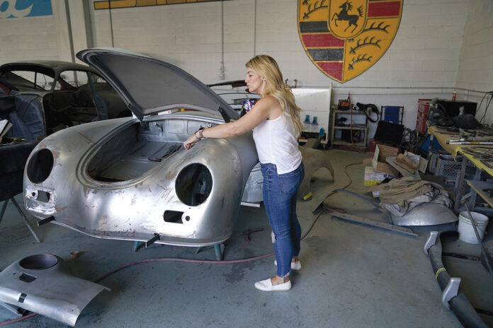 BACK ON THE JOB: Laurina Esposito, co-owner of Espo Restoration, inspects a car frame at her Los Angeles shop. Esposito and her business partner were diagnosed with coronavirus in early September. / AP PHOTO/ MARCIO JOSE SANCHEZ
