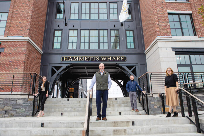 STANDING READY: Outside Hammetts Hotel in Newport are, from left, General Manager Randi Milewski, Colin Kane and Sam Bradner, two of the hotel owners, and Sarah Eustis, CEO of the Main Street Hospitality Group, the company handling the hotel’s management. The hotel opened in June amid the uncertainty of the pandemic. / PBN PHOTO/KATE WHITNEY LUCEY