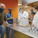 MIXING materials: Blount Fine Foods Corp. positional instructors, from left, Mike Smith and Eddy Anlen, learn about starches from research and development chefs Clayton Burrows and Leanne Koch./COURTESY BLOUNT FINE FOODS CORP.