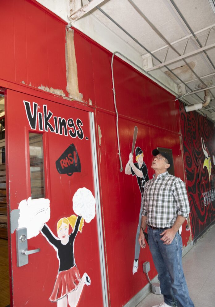 JEFF WATTS, plant engineer at Rogers High School in Newport, examines a problem area at the school, outside the gymnasium, where water has delaminated the wall. Newport voters on Tuesday approved a $106.3 million school bond measure, where most of the funds will be used to build a new Rogers High School. / PBN FILE PHOTO/MICHAEL SALERNO