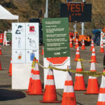 READY AND WAITING: Instructions to perform a COVID-19 virus self-test are displayed for drivers outside Dodger Stadium in Los Angeles. The site can handle 6,000 tests in a day. With sites such as this already operating nationwide, experts say there are reasons to think the U.S. is better able to deal with a surge in cases. / AP FILE PHOTO/DAMIAN DOVARGANES