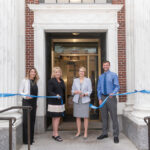 FRESH LOOK: BankNewport administrators cut the ribbon on the recently restored branch in Newport’s Washington Square. Pictured, from left, are Amy Riccitelli, senior vice president and director of retail sales; Mary Leach, executive vice president and director of consumer relationships; Sandra J. Pattie, CEO and president; and Evan Rose, vice president and branch sales manager. / COURTESY BANKNEWPORT