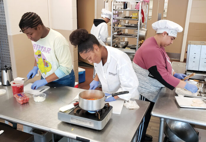 THE RIGHT INGREDIENTS: William M. Davies Jr. Career & Technical High School students, from left, Miracle Dunn, Aiden Nivar-Julius, Dorothy Tavares and Madyisen DaGraca sharpen their cooking skills in a culinary class.  / COURTESY WILLIAM M. DAVIES JR. CAREER & TECHNICAL HIGH SCHOOL