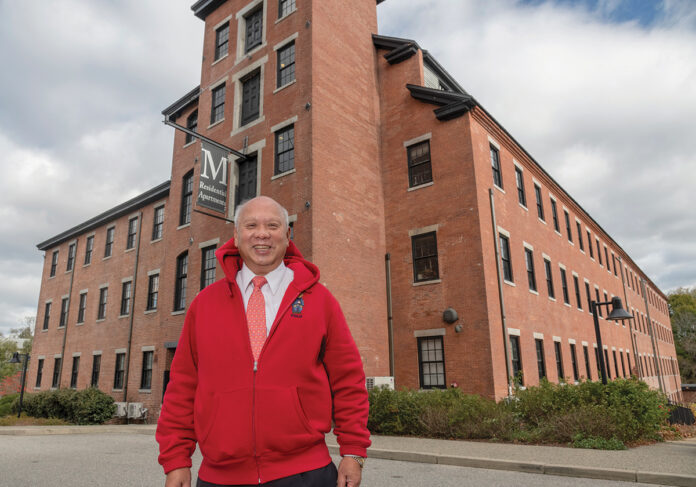A BIG DEAL: Louis Yip stands outside a mill building in Central Falls that his real estate group purchased and converted into a 175-unit apartment complex called M Residential. / PBN PHOTO/MICHAEL SALERNO
A BIG DEAL: Louis Yip stands outside a mill building in Central Falls that his real estate group purchased and converted into a 175-unit apartment complex called M Residential. / PBN PHOTO/MICHAEL SALERNO