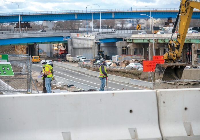 UP-ROUTED: Construction workers are on-site at the Westminster Street overpass, part of the Route 6-10 connector project in Providence. Visible in the background is the “flyover” bridge, a major feature of the new design for the busy exchange.  / PBN PHOTO/MICHAEL SALERNO