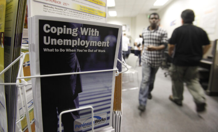 THERE WERE 70,136 individuals collecting some form of unemployment benefit in Rhode Island last week. / AP FILE PHOTO/PAUL SAKUMA