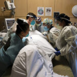 ACROSS THE U.S.., the COVID-19 surge has swamped hospitals with patients and left nurses and other health care workers shorthanded and burned out. / AP FILE PHOTO/JAE C. HONG