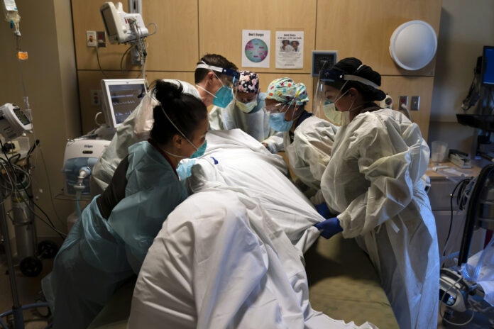 ACROSS THE U.S.., the COVID-19 surge has swamped hospitals with patients and left nurses and other health care workers shorthanded and burned out. / AP FILE PHOTO/JAE C. HONG