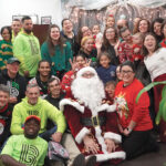 holiday cheer: Big Brothers Big Sisters of Rhode Island employees gather for a Christmas party at the office. COURTESY BIG BROTHERS BIG SISTERS OF RHODE ISLAND