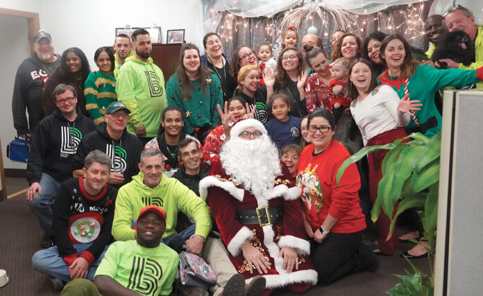 holiday cheer: Big Brothers Big Sisters of Rhode Island employees gather for a Christmas party at the office. COURTESY BIG BROTHERS BIG SISTERS OF RHODE ISLAND